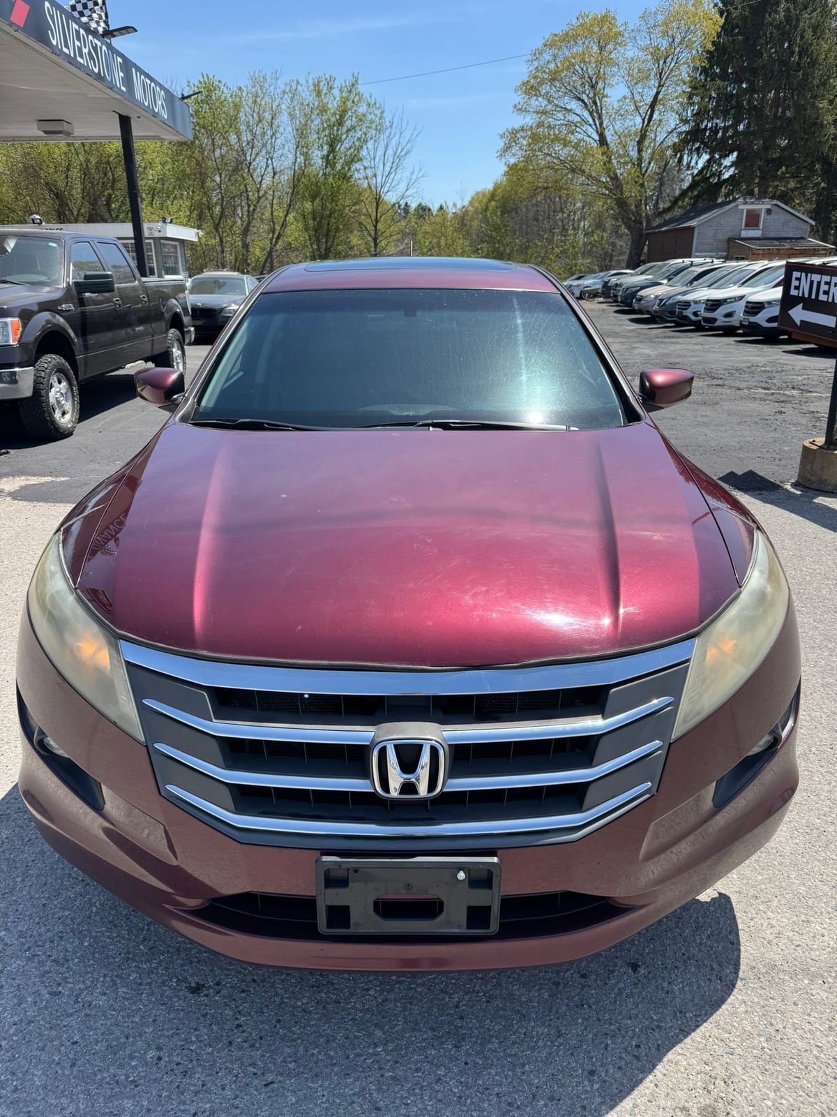 2012 Honda ACCORD CROSSTOUR EX-L 4WD W/NAVIGATION 4DR BURGANDY front exterior view in dealership lot with tinted windshield and chrome grille.