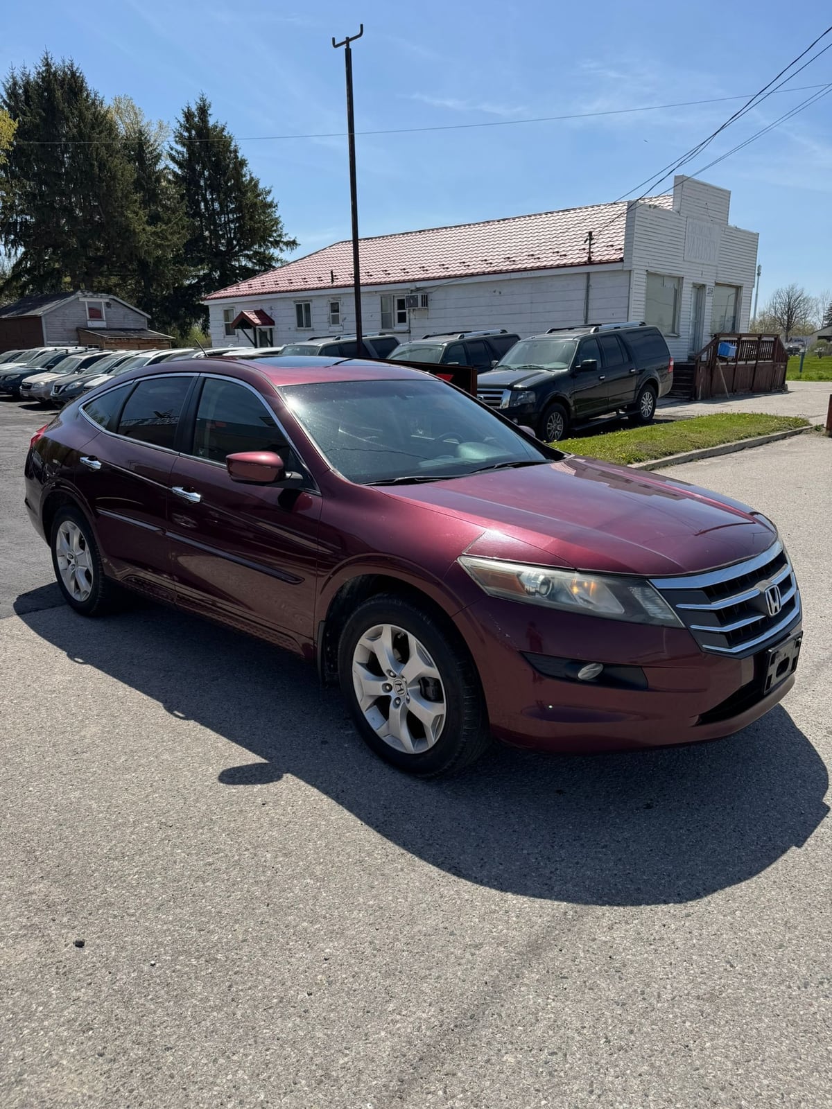 2012 Honda ACCORD CROSSTOUR EX-L 4WD W/NAVIGATION 4DR BURGANDY front three-quarter exterior view with chrome alloy wheels in dealership lot.