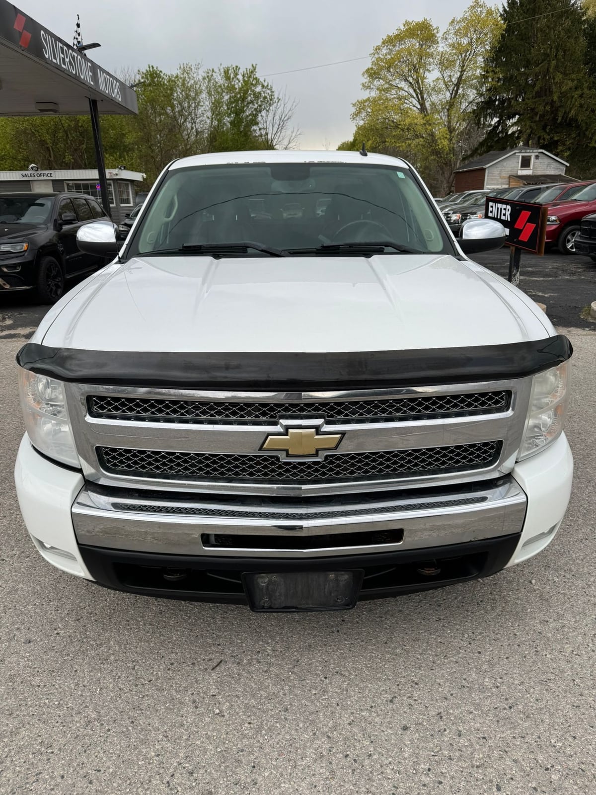 2011 Chevrolet SILVERADO LTZ 4WD EXTENDED CAB STANDARD BOX White front exterior view showing distinctive dual grille design and chrome trim.