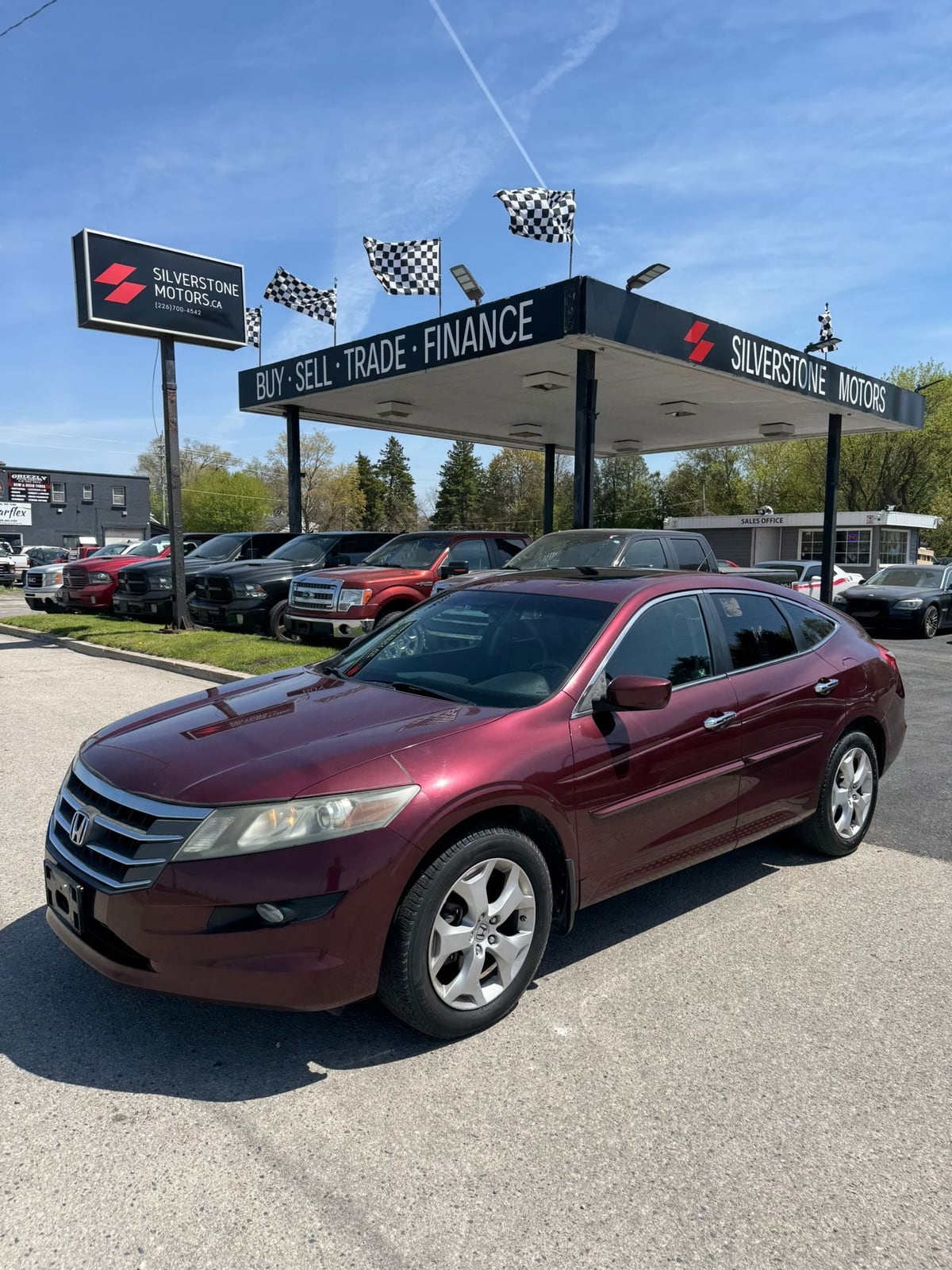 2012 Honda ACCORD CROSSTOUR EX-L 4WD W/NAVIGATION 4DR BURGANDY front three-quarter exterior view at dealership with chrome alloy wheels and clear skies.