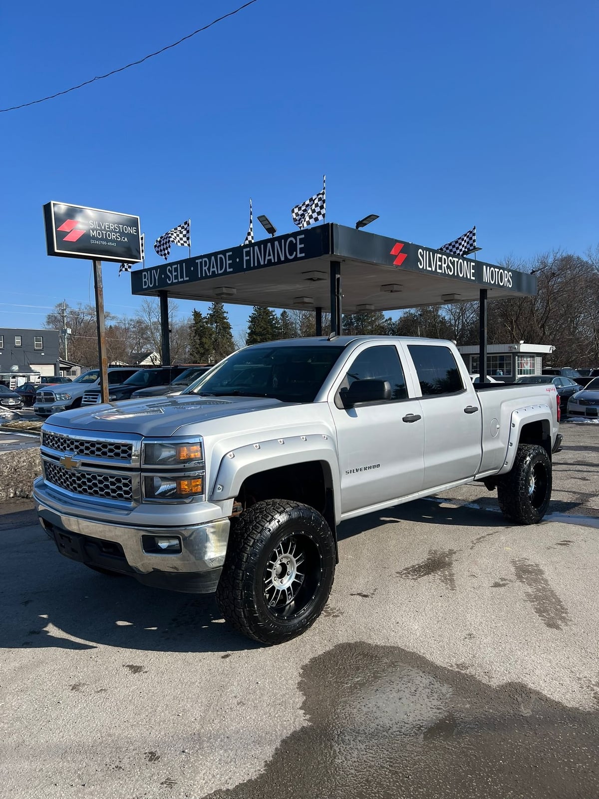 2014 Chevrolet SILVERADO 1500 LT w/1LT 4WD CREWCAB SILVER front three-quarter exterior view with custom alloy wheels at dealership lot.