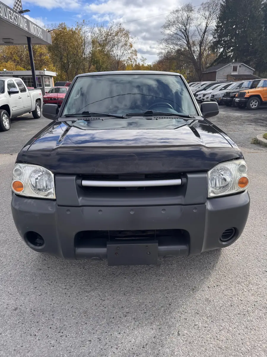 2003 Nissan Frontier XE 3.3 V6 4X4 Crew Cab Standard Box Black front exterior view at dealership lot with chrome grille.