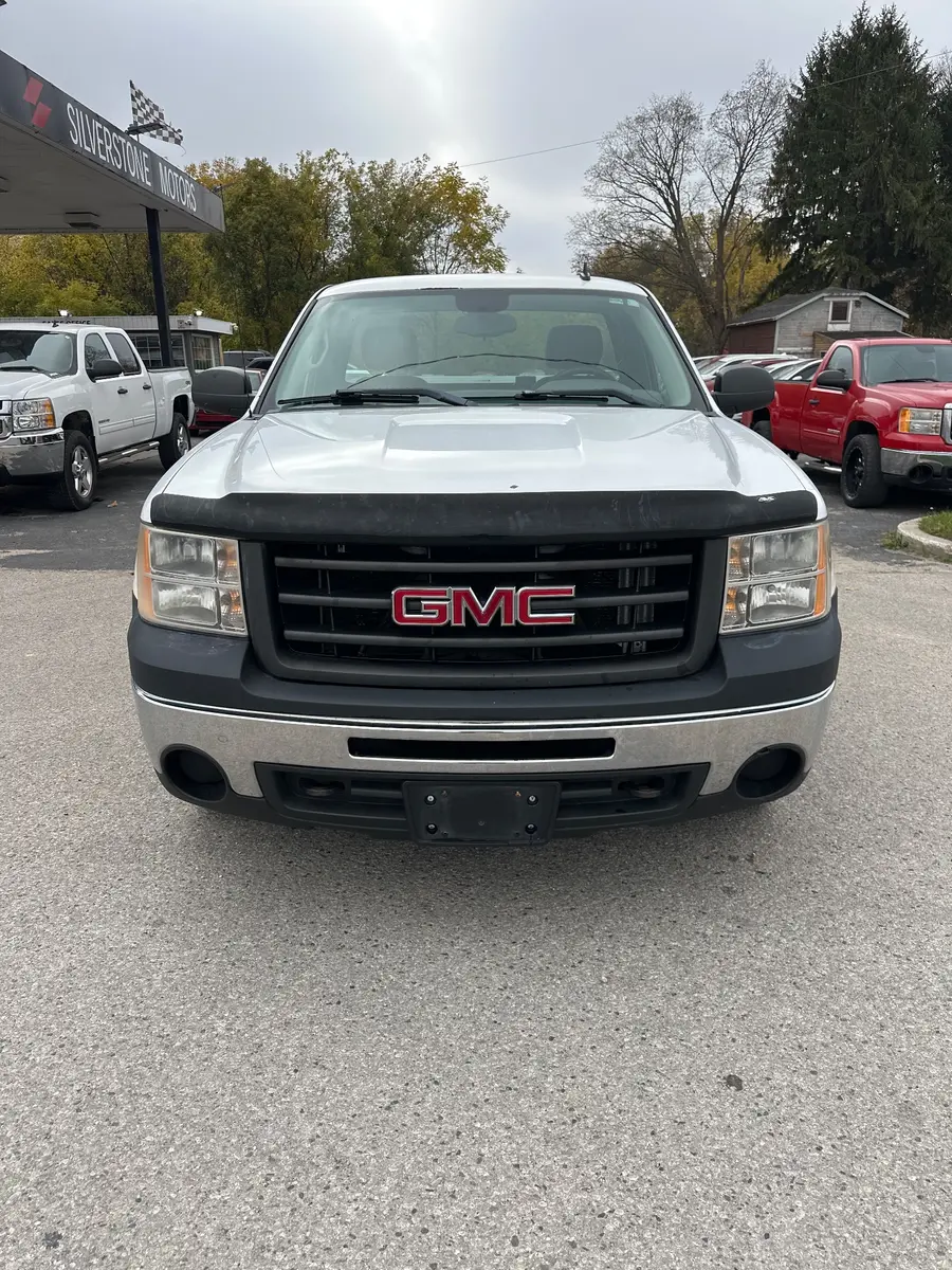2011 GMC Sierra LS REGULAR CAB SHORT BOX White front exterior view with black grille and hood protector in dealership lot.