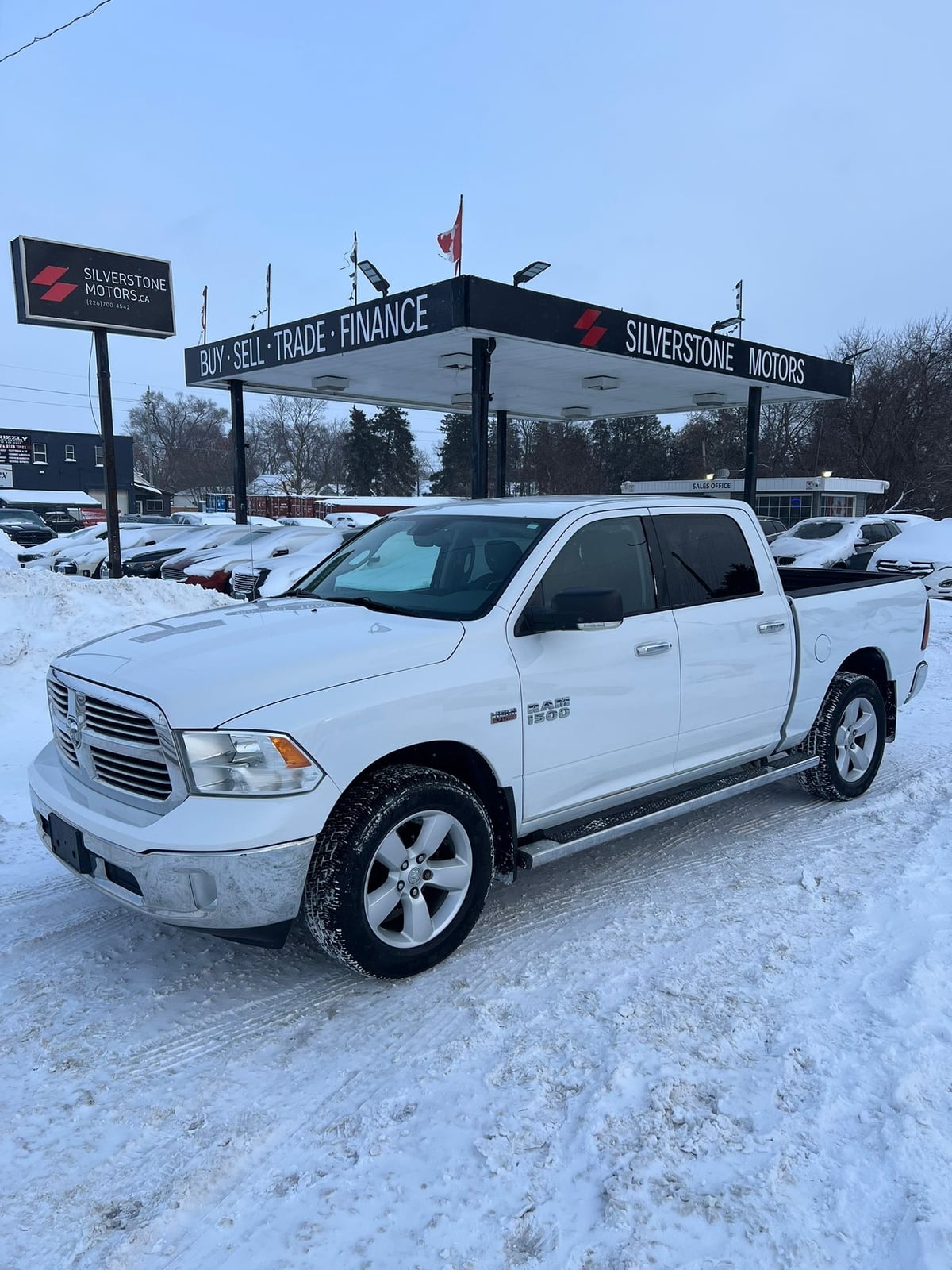 2013 RAM 1500 SLT CREW CAB 4WD SHORT BOX White, front three-quarter exterior view at snowy dealership lot with alloy wheels visible.