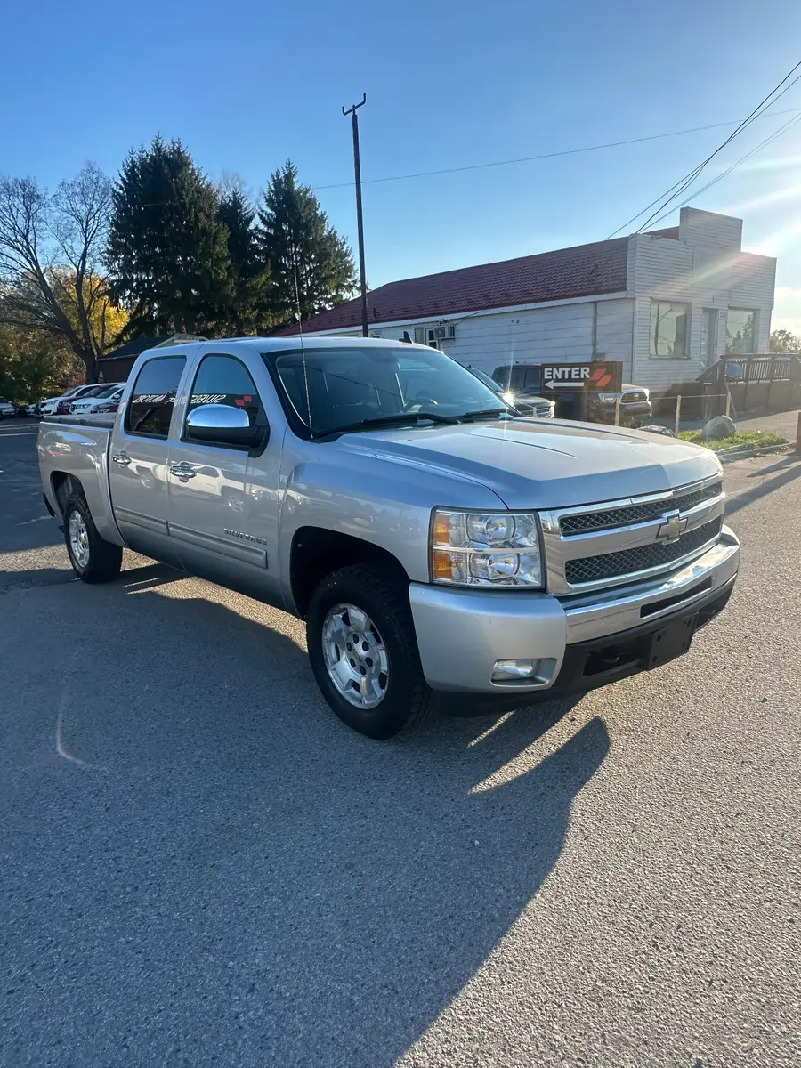 2011 Chevrolet Silverado LT Z71 Crew Cab Short Box Silver front three-quarter exterior view with chrome grille and alloy wheels in daylight.