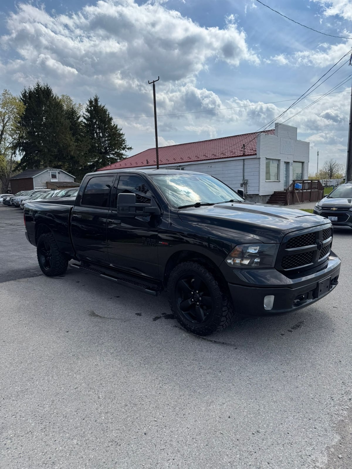2018 RAM 1500 BIGHORN 4X4 CREW CAB STANDARD BED BLACK front three-quarter exterior view with black alloy wheels parked in daylight.