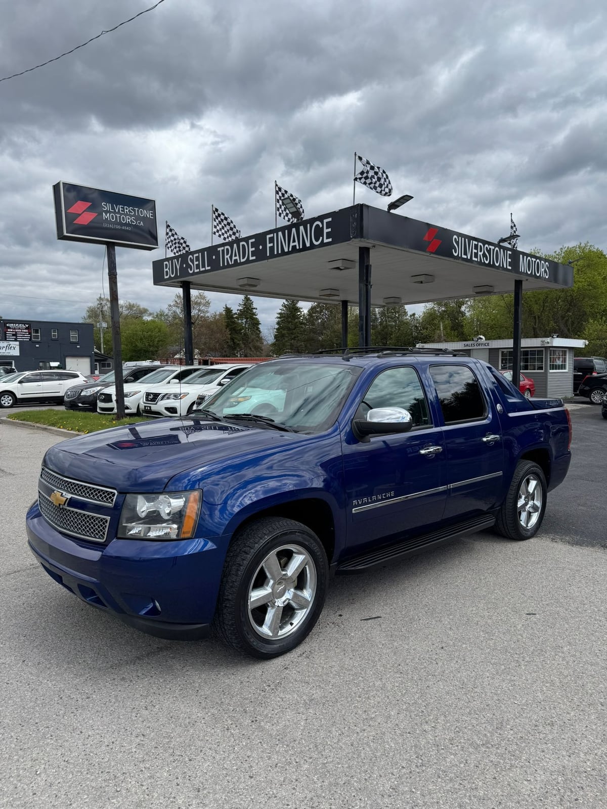 2013 Chevrolet Avalanche LTZ Black Diamond Edition 4X4 Crew Cab Blue front three-quarter exterior view at dealership with chrome wheels and badging visible.
