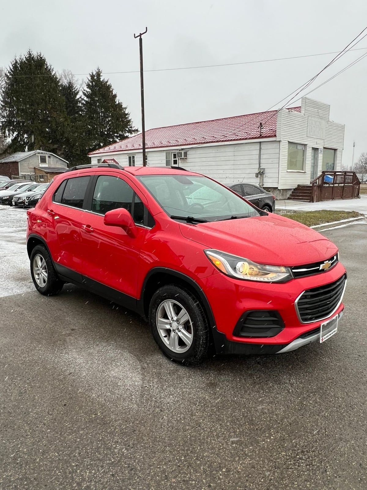 2017 Chevrolet TRAX LT AWD 4DR RED front three-quarter exterior view with silver alloy wheels parked in dealership lot.