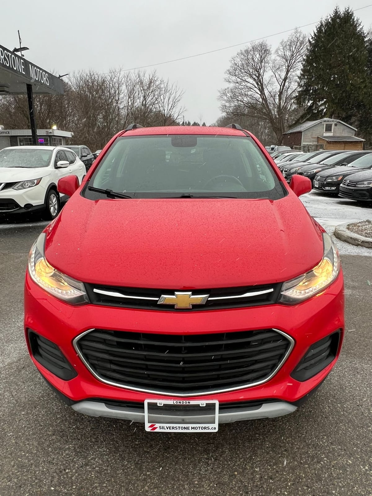 2017 Chevrolet TRAX LT AWD 4DR RED front exterior view showing distinctive dual-tier grille and LED headlights at dealership lot.